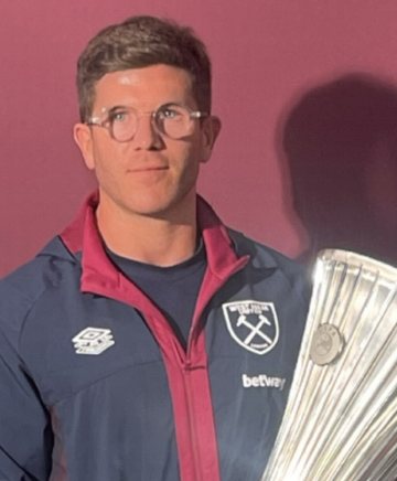 Matt Jones in West Ham training kit holding the UEFA Europa Conference League trophy